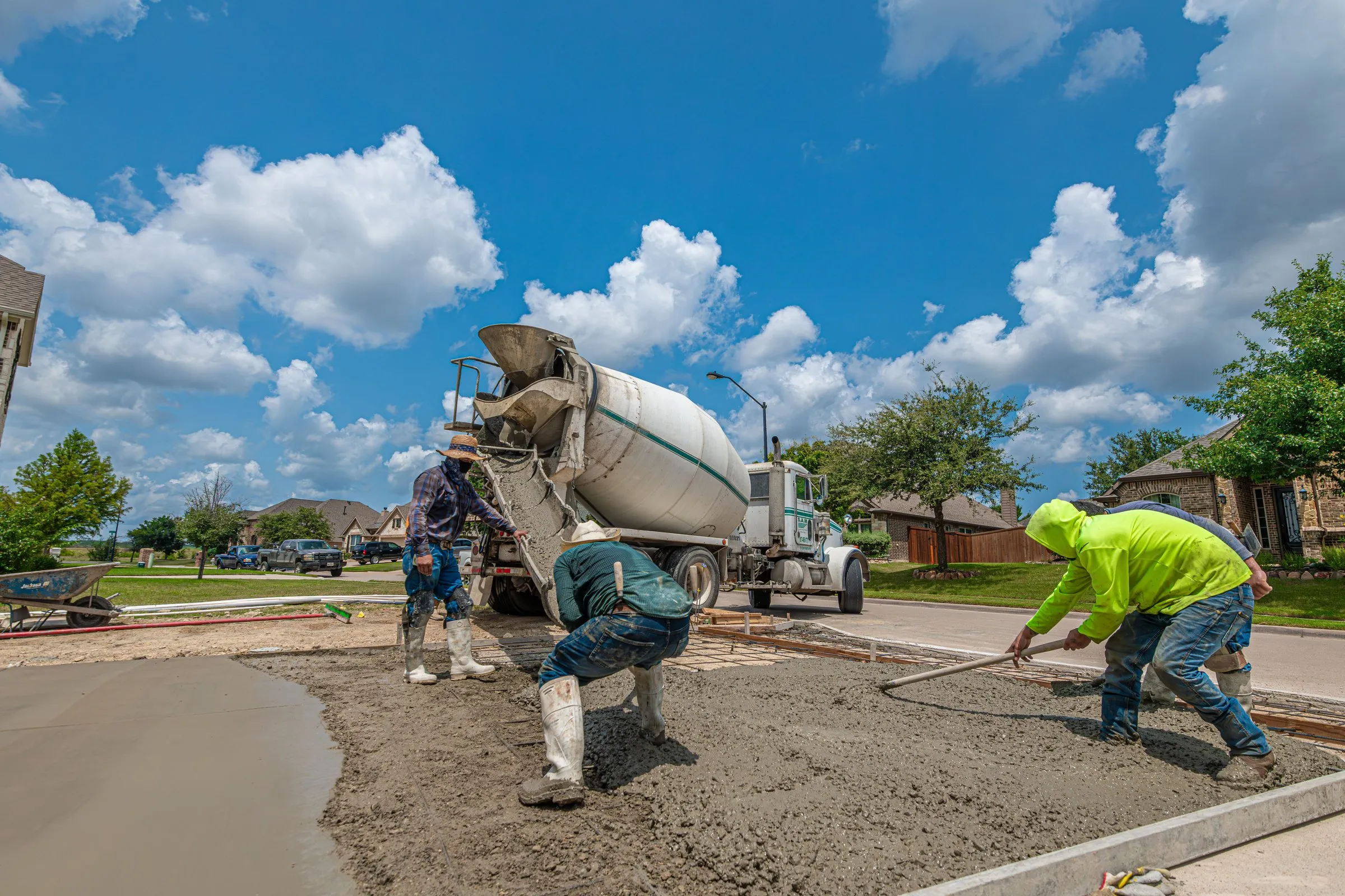 Crew pouring a concrete driveway