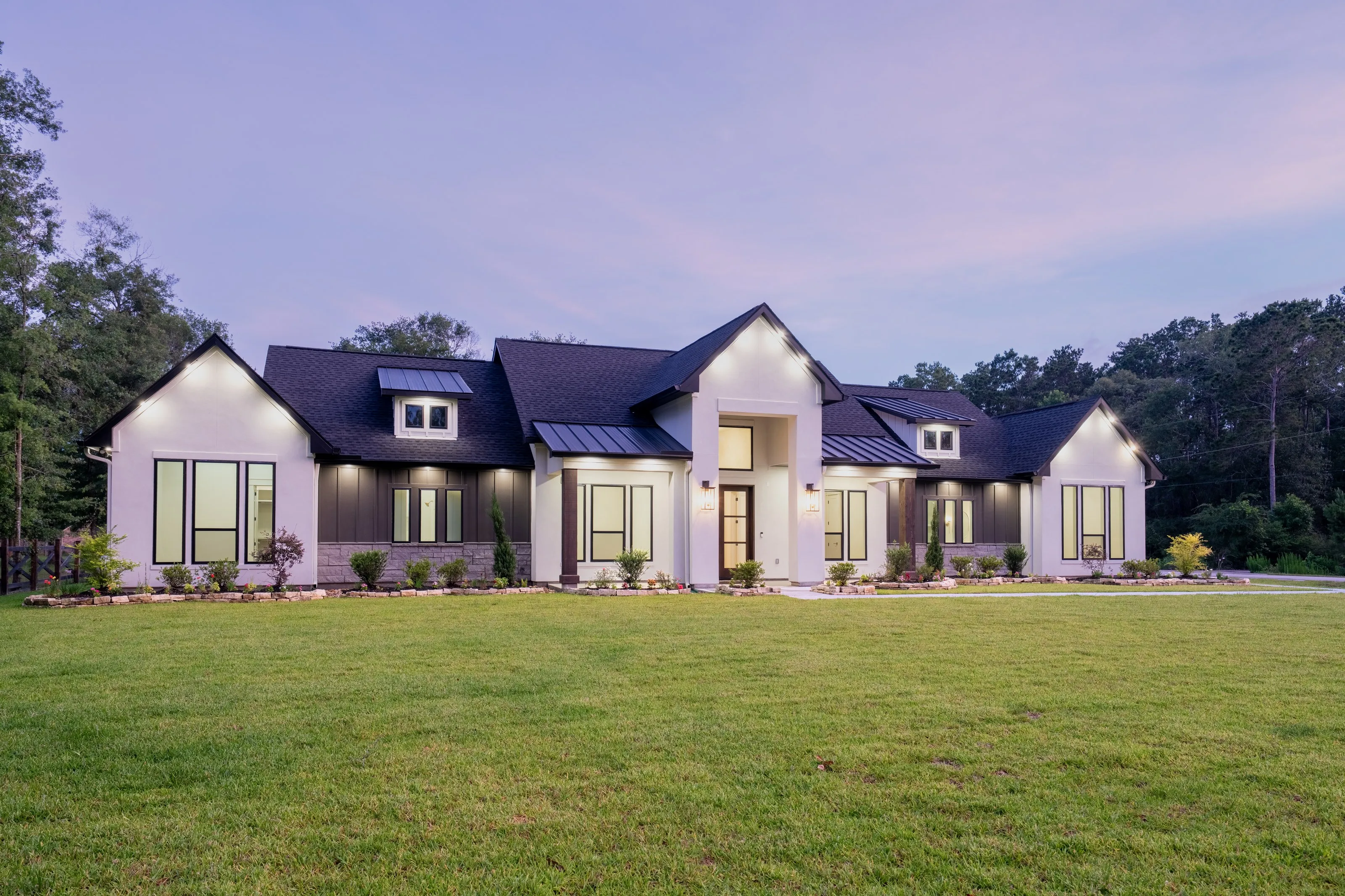 Custom home exterior at dusk, one of Summit Society Co.'s recent projects