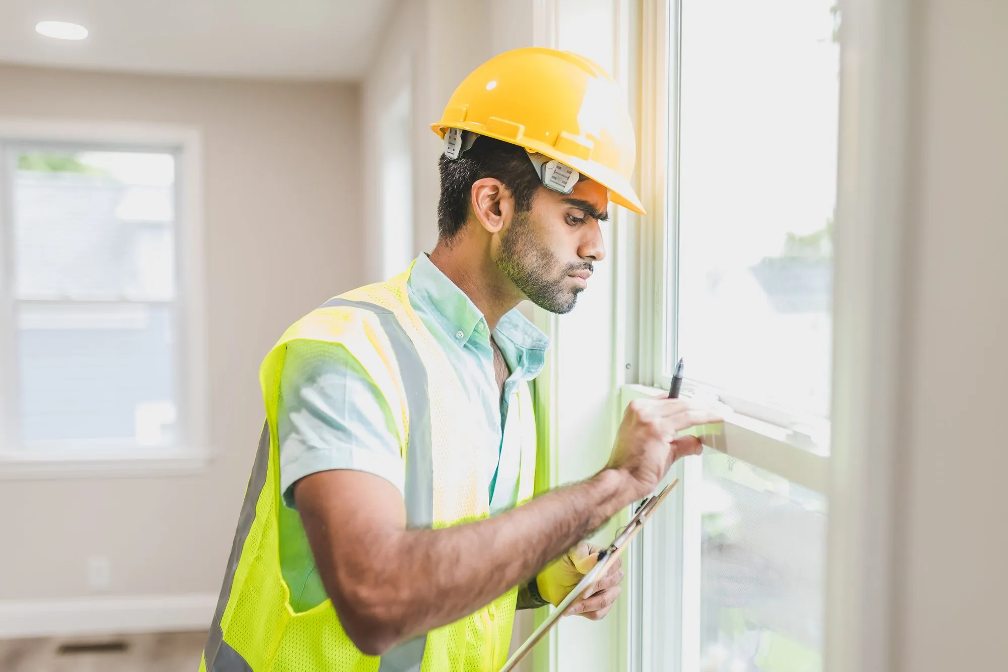 Contractor in hard hat and safety vest on an active job site