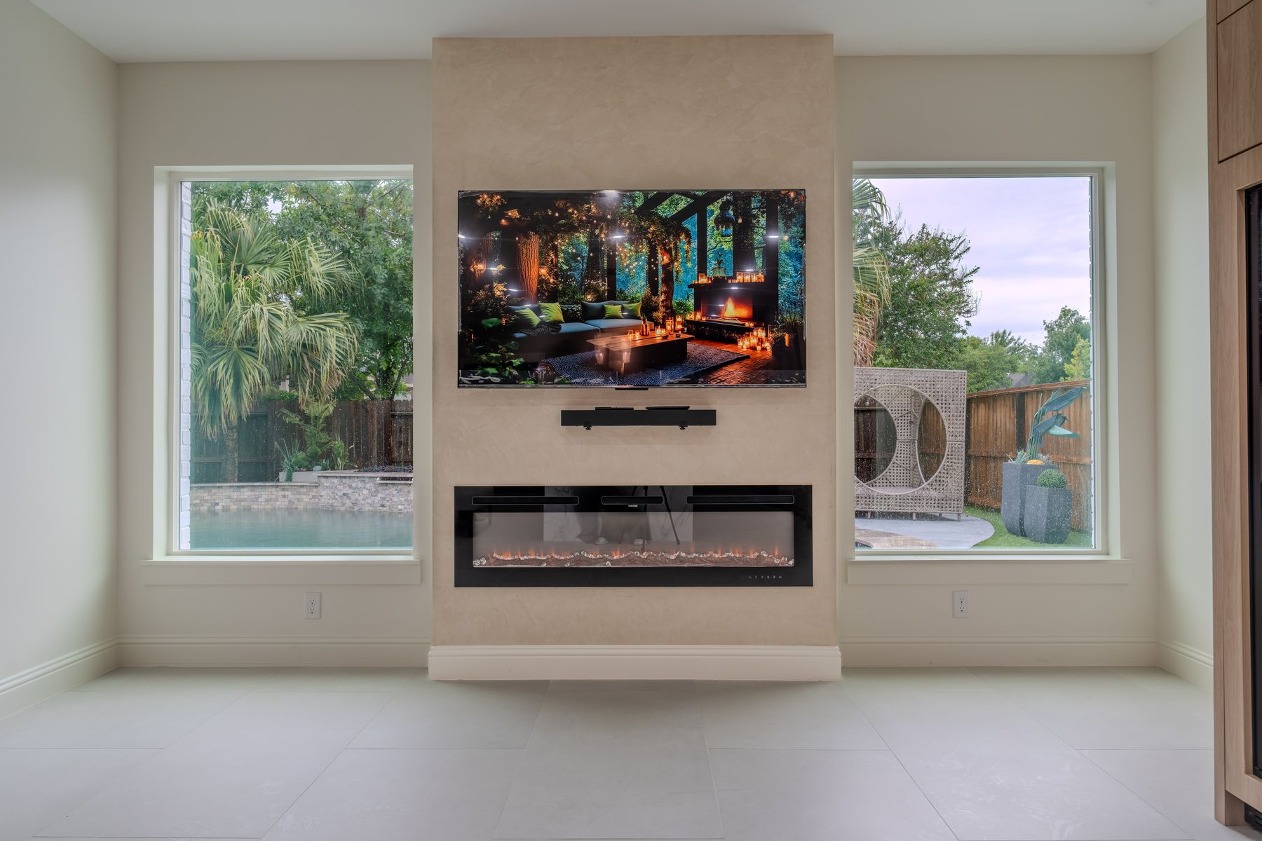 Living room fireplace wall with pool views on both sides